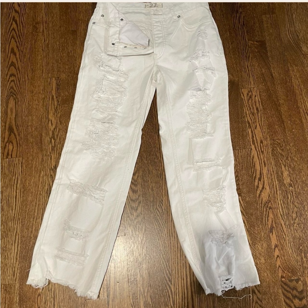 Free people white distressed, button fly, straight leg, raw hem jeans.